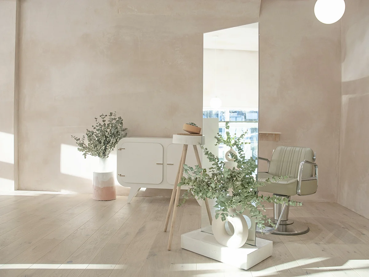 Natural light and pale green styling chairs inside KOOP London